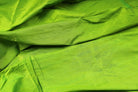 Lime Green Dupion Silk Fabric displayed with soft folds revealing natural silk texture, luminous finish, and vivid lime-green tones