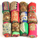 White background showing 12 rolls of embellished Saree Silk Ribbon
