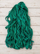 Full-length emerald chiffon silk ribbon yarn strands displaying flowing texture