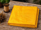 Golden Yellow Dupion Silk Fabric folded to showcase its radiant golden-yellow colour, natural silk texture, and lustrous sheen