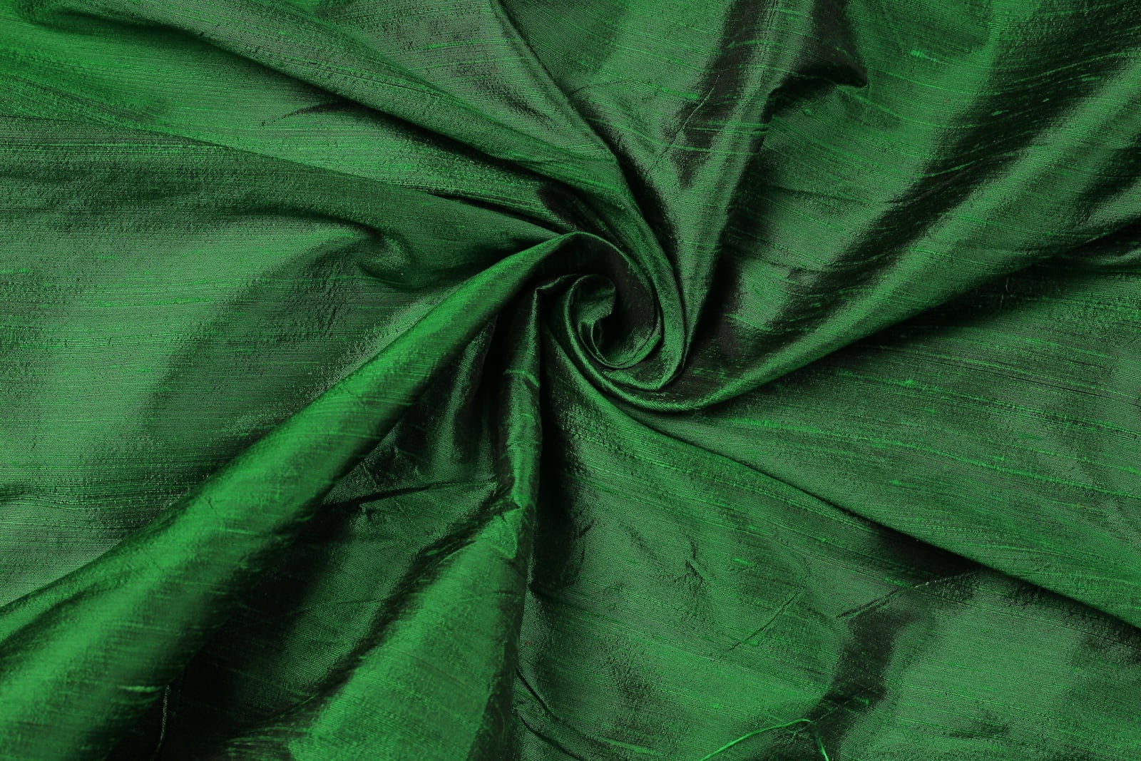 Emerald Green Dupion Silk Fabric arranged in elegant swirling folds highlighting its luxurious sheen, natural slub texture, and vibrant emerald colour
