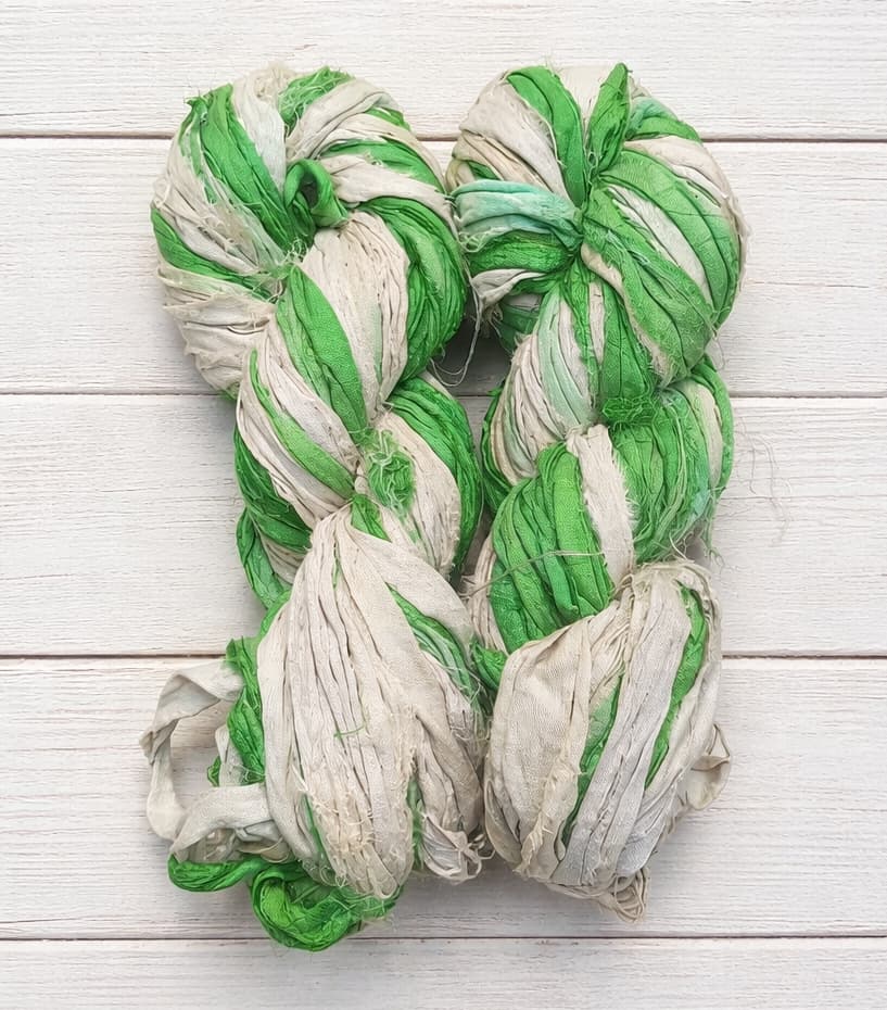 Green and ivory sari silk ribbon yarn skeins made from recycled silk sari fabric