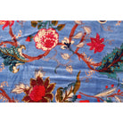 Close-up of red floral print on light blue hand-printed cotton velvet fabric