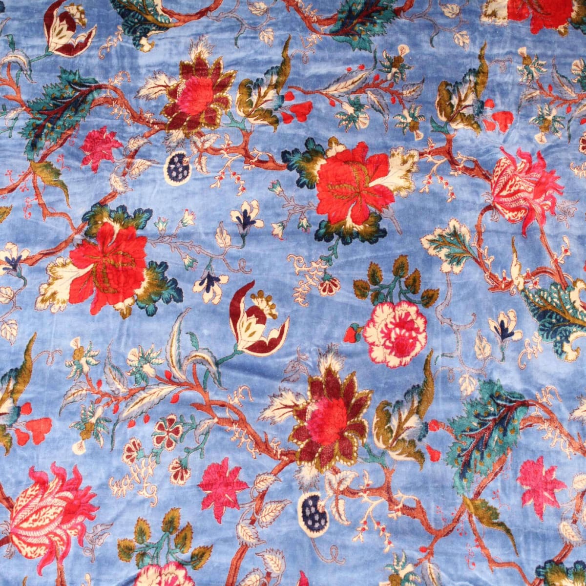 Hand-printed sky blue cotton velvet with red and maroon floral pattern – flatlay view