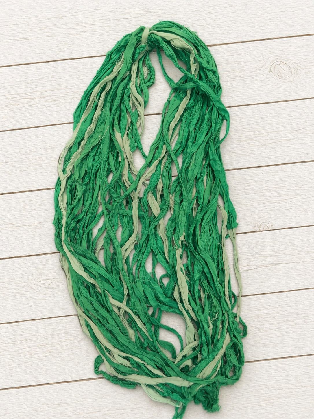 Hand dyed Spring Fern sari silk ribbon yarn draped to display texture