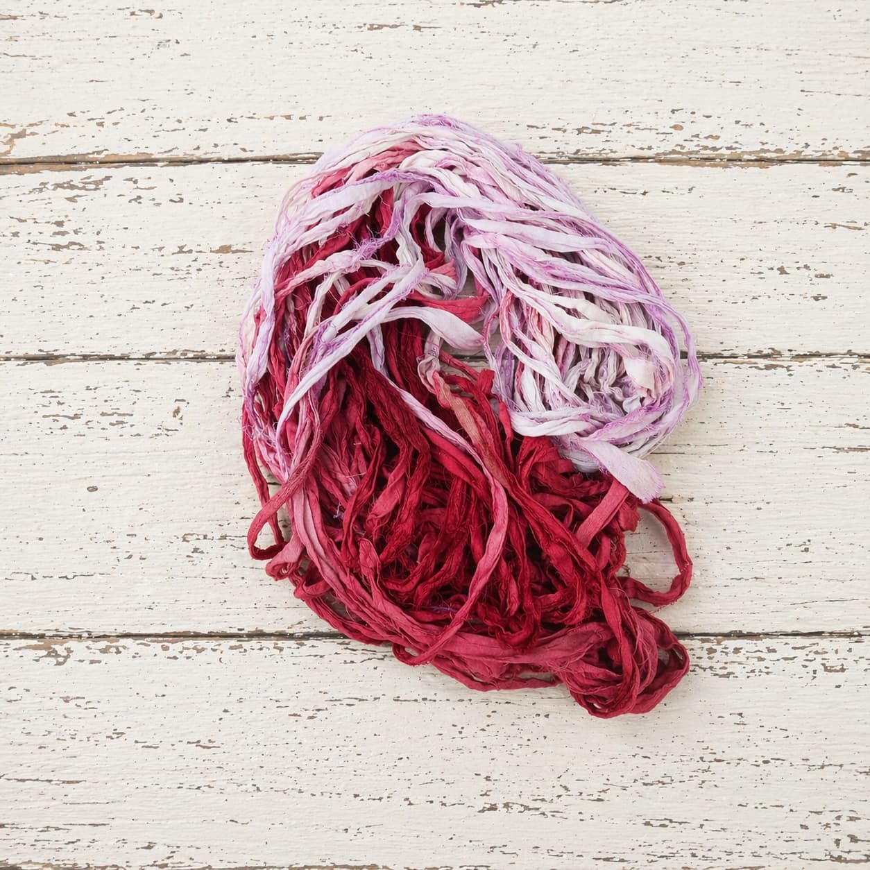 Berry Blossom sari silk ribbon yarn coiled in crimson rose and lavender shades