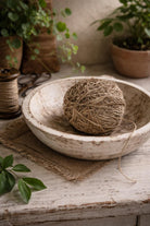 Handspun nettle yarn styled in a wooden bowl for eco friendly fiber art projects