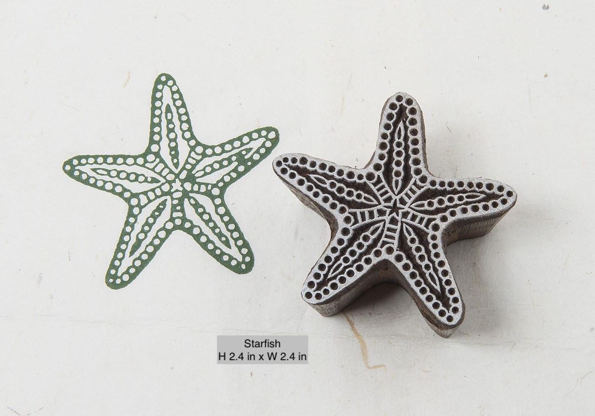 Classic hand-carved starfish wooden printing stamp on a cream background