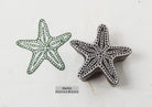 Classic hand-carved starfish wooden printing stamp on a cream background