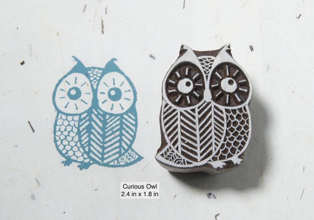 Curious owl hand carved wood block print stamp with bold eyes and geometric detailing