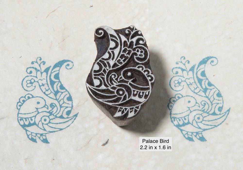 Traditional Indian palace bird wood printing block with ornate folk design printed in blue ink.