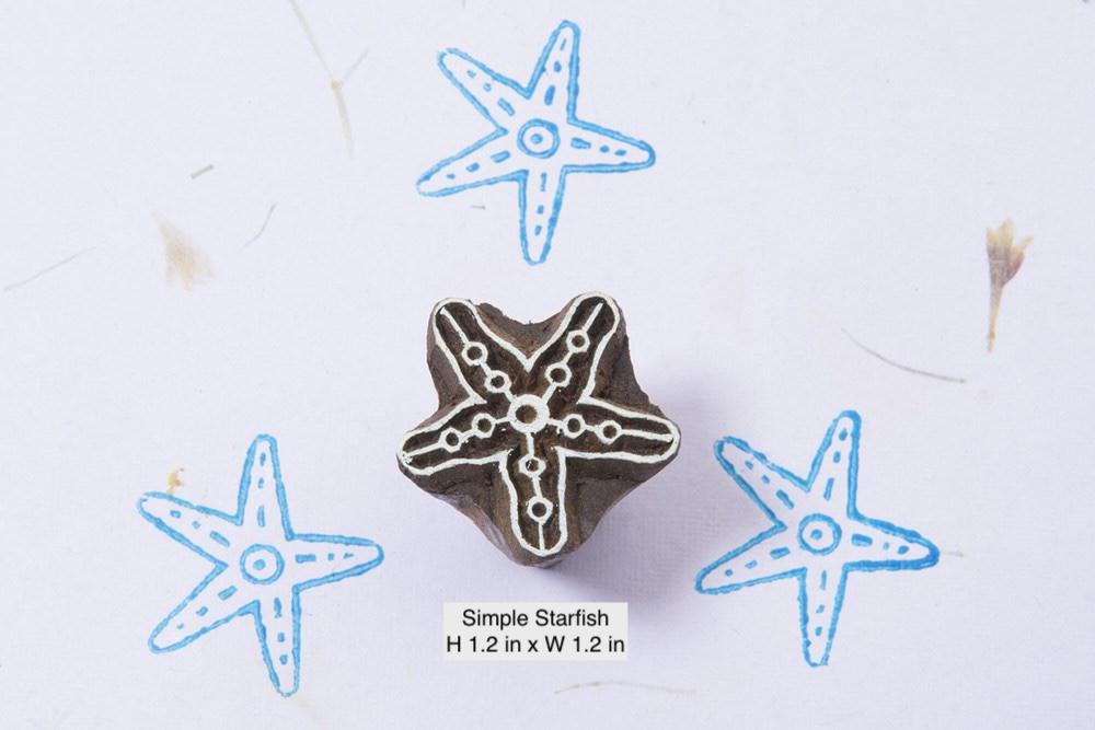 Simple hand-carved starfish wooden printing stamp on a white background