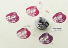 Spiral seashell hand carved wooden stamp creating bold textile print patterns