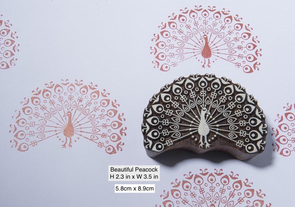 Traditional Indian peacock wooden printing block with detailed feathers shown alongside repeated printed pattern.