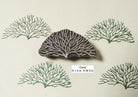 Hand carved coral-inspired wooden printing block creating organic sea life patterns on paper.
