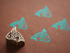 Hand carved fish wooden printing block with stamped blue images on brown craft paper...used for pottery, textile, paper  block printing