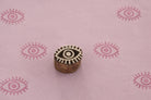 Carved wooden evil eye block stamp printing pink eye pattern on handmade paper