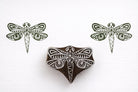 Hand carved wooden dragonfly block printing stamp creating green dragonfly prints on white paper background.