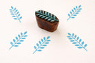 Indian wooden leaf block printing stamp creating blue botanical pattern on fabric