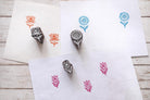 Hand carved wooden floral block printing stamps showing lotus tulip and sunflower prints on handmade paper.
