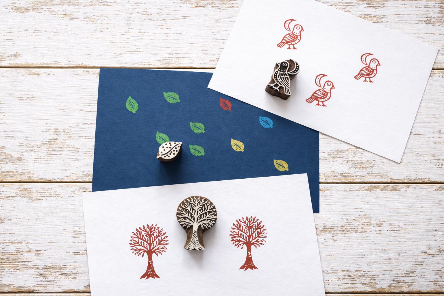 Tree, bird and leaf wood block stamps with printed pattern examples on handmade paper.