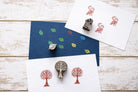 Tree, bird and leaf wood block stamps with printed pattern examples on handmade paper.