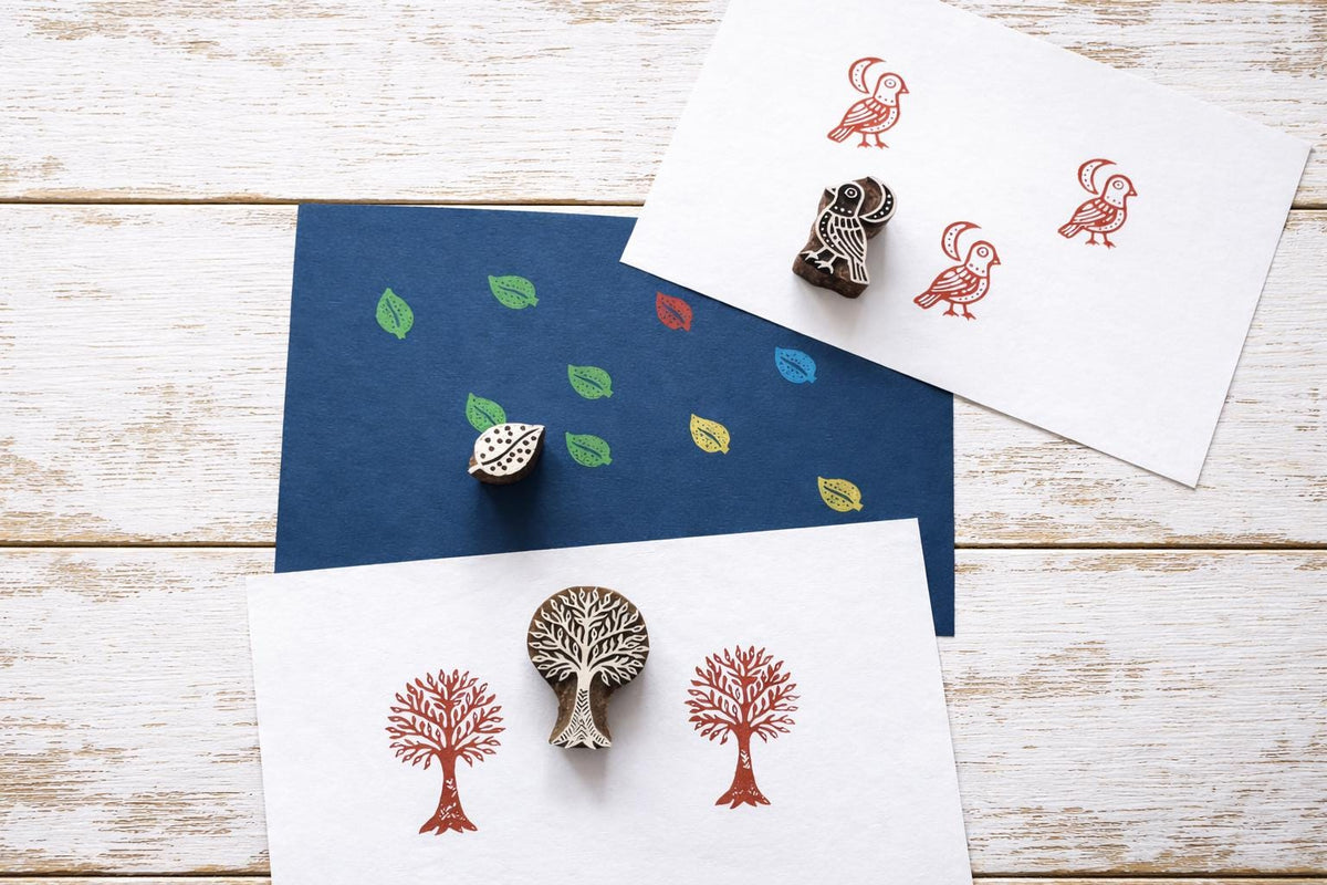 Tree, bird and leaf wood block stamps with printed pattern examples on handmade paper.