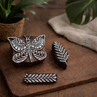 Hand carved Indian wooden printing blocks featuring butterfly and leaf designs used as fabric stamps and textile printing blocks.