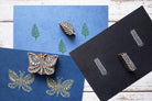 Indian wooden printing blocks used for textile printing with butterfly and leaf fabric stamp patterns.