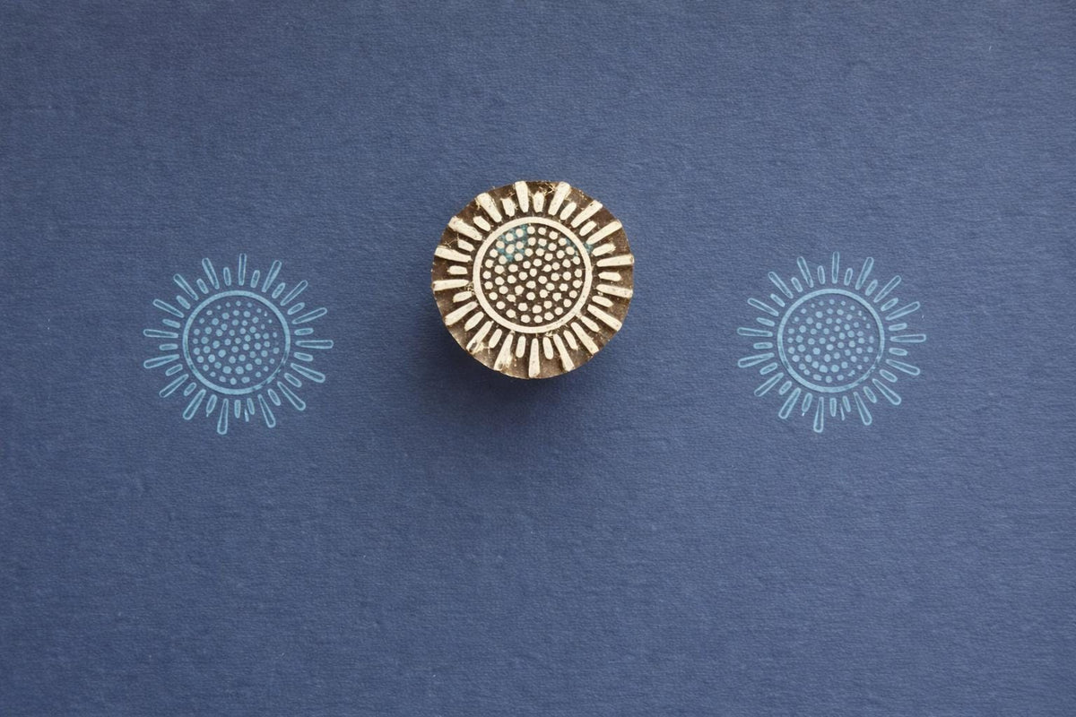 Hand carved sunburst wooden block printing stamp used for textile printing, fabric stamping, pottery and clay crafts.