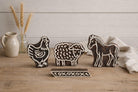 Hand carved wooden block printing stamps featuring chicken, sheep, horse and geometric border for fabric printing, pottery, clay and textile crafts.