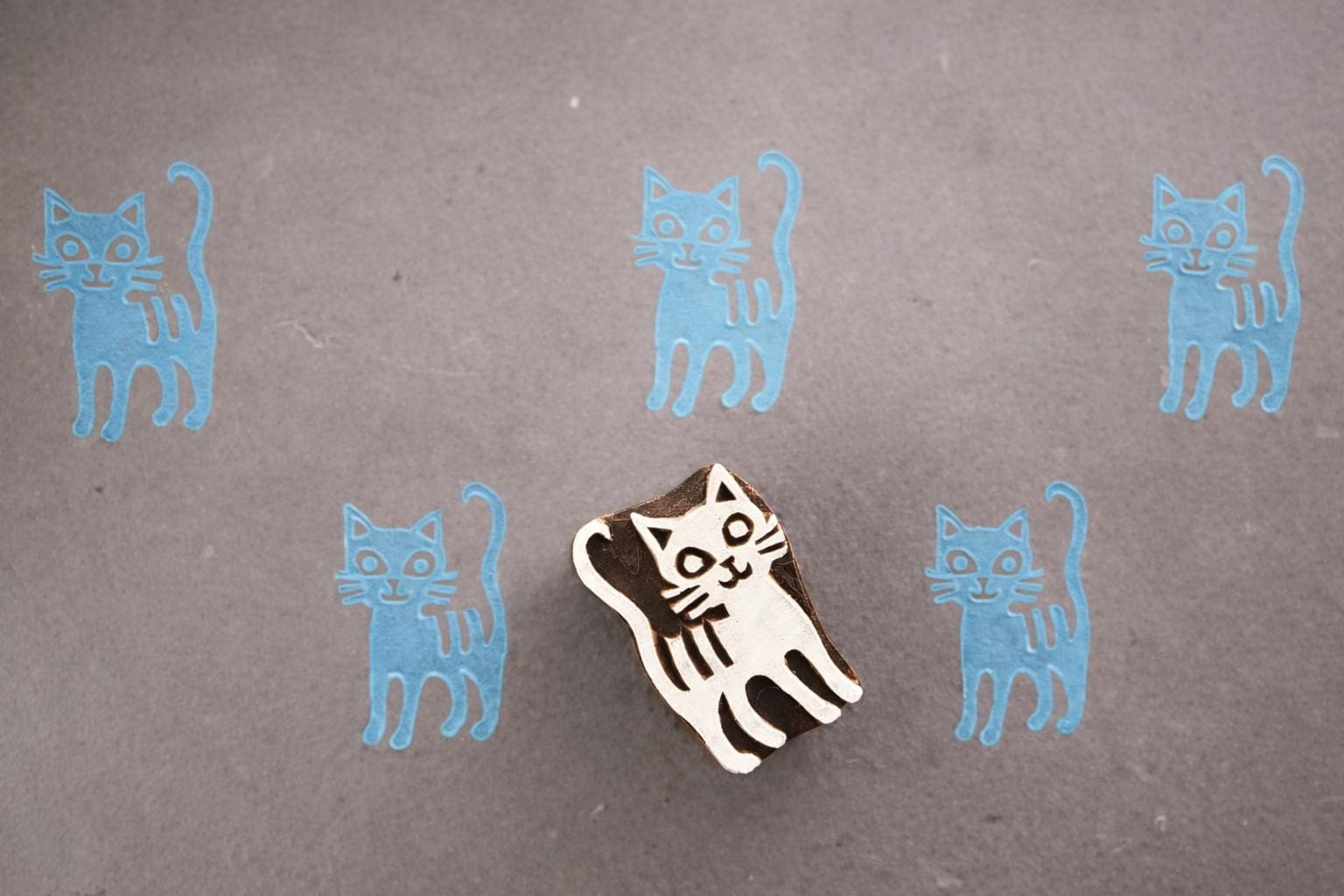 Striped cat wooden printing block blue print on greyish paper