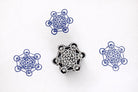 Hand carved wooden Metatron’s Cube block printing stamp creating blue sacred geometry prints on white paper.
