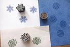 Hand carved sacred geometry block printing stamps showing Metatron cube, Sri Yantra and Flower of Life prints on handmade paper.