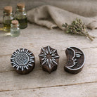 Hand carved Indian wooden block printing stamps featuring sun, starburst and crescent moon face designs for textile, fabric, clay and pottery printing.