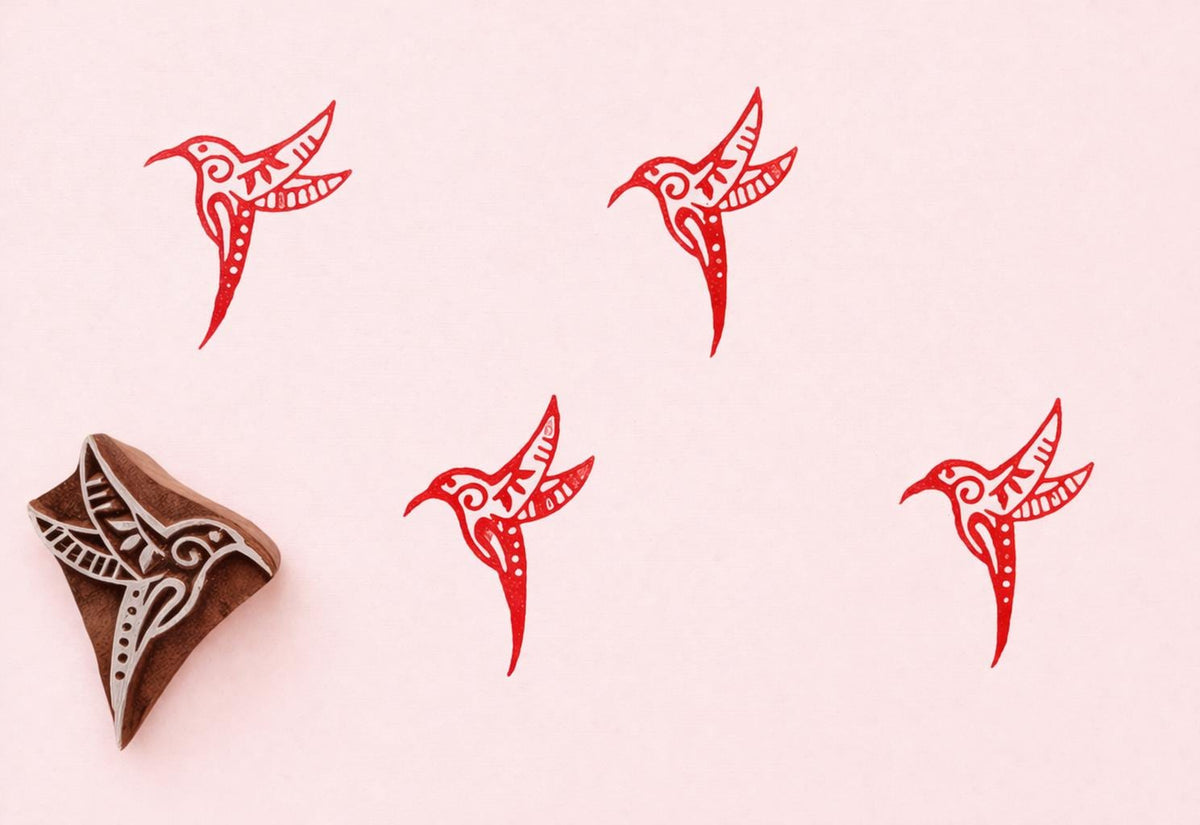 Handmade hummingbird wood stamp with red printed bird patterns on paper