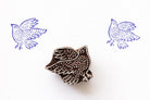 Wooden block stamp featuring a flying bird with detailed carved pattern and blue prints