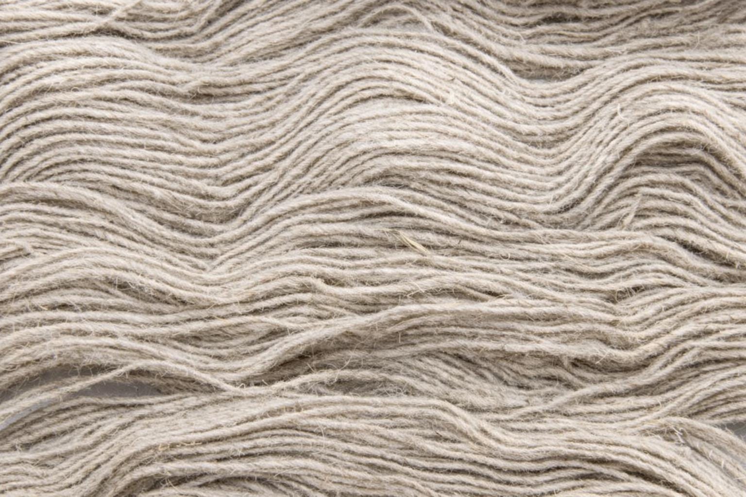 Close up texture of machine spun hemp and wool blend yarn showing natural fiber detail