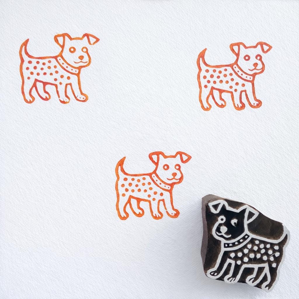 Decorative dog block print stamp with orange ink pattern on paper