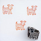 Decorative dog block print stamp with orange ink pattern on paper
