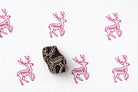 Deer block print pattern in pink ink on paper with wooden stamp