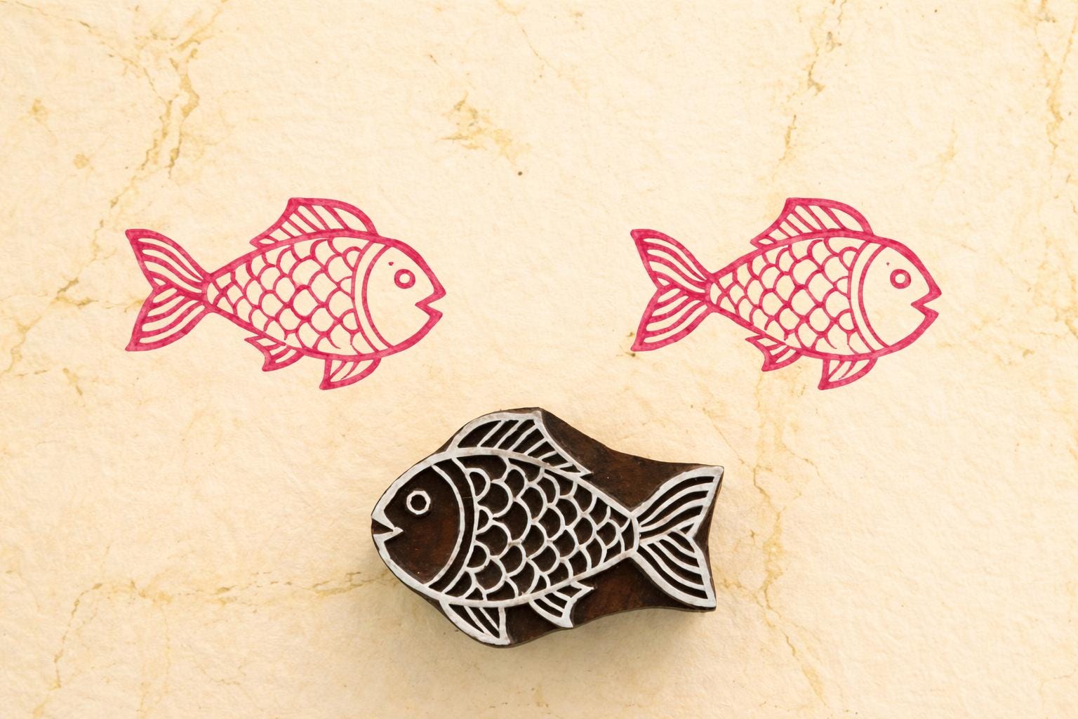 Fish wooden printing block used on fabric showing pink textile print block print stamp for fabric