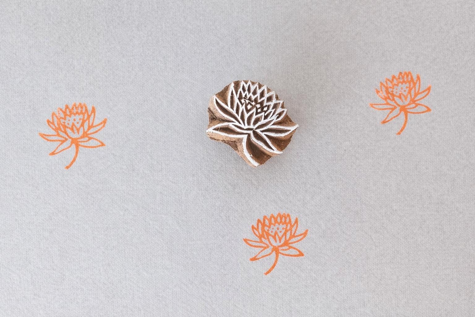 Hand carved lotus mini stamp printing orange floral pattern on fabric