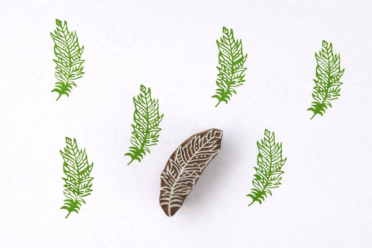 Etched Feather Block wooden stamp creating repeating feather pattern in green ink