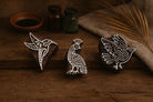Set of three hand-carved wooden block stamps with bird designs on rustic background