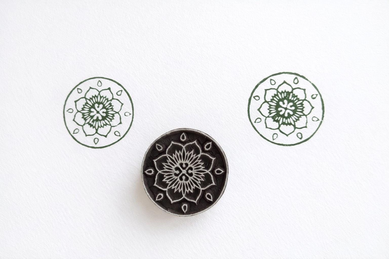 Hand carved wooden round stamp printing floral mandala with symbol pattern