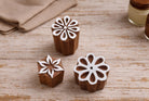 Set of three hand carved wooden flower stamps with star, round, and loop petal designs