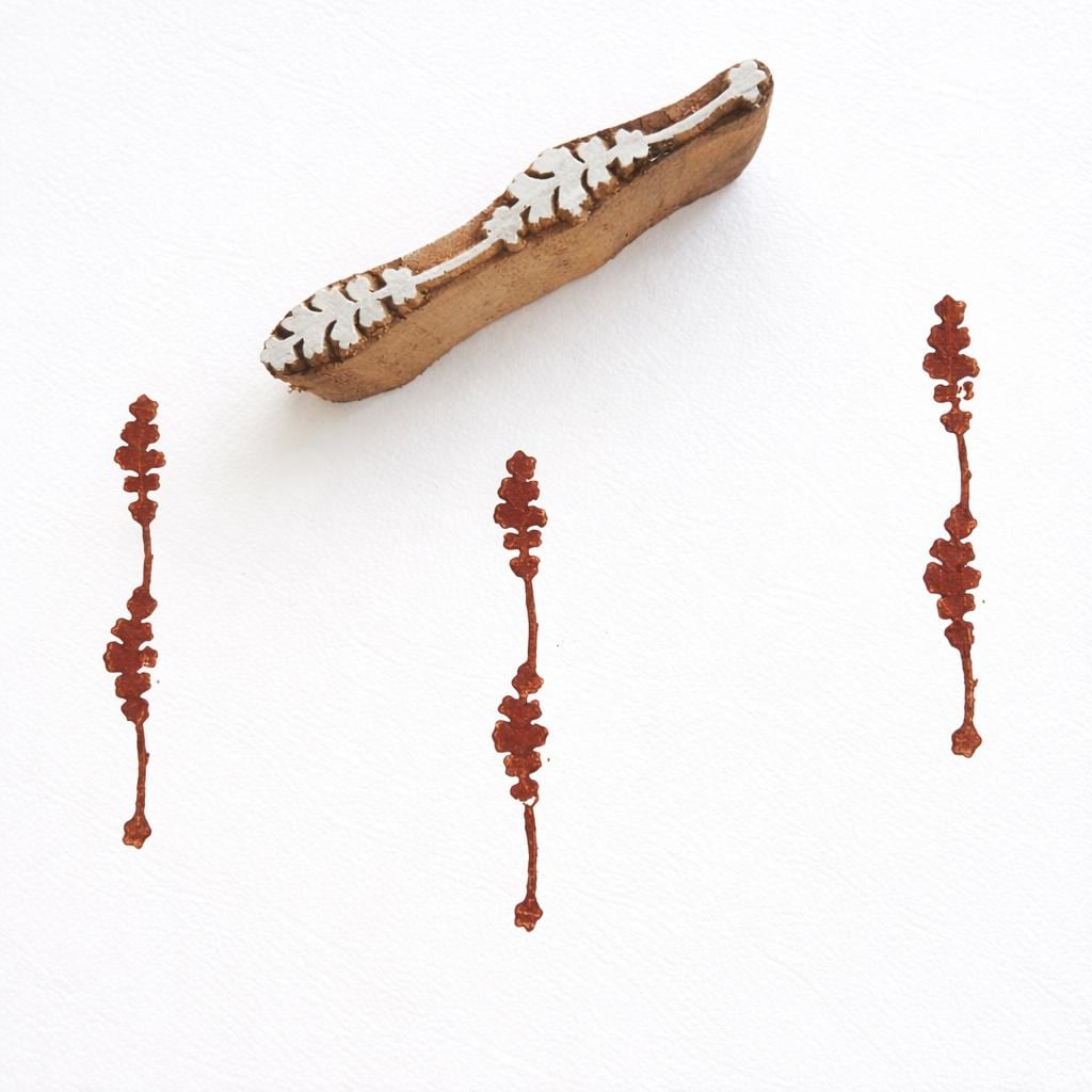 Hand carved wooden stamp printing small vertical floral strip border pattern