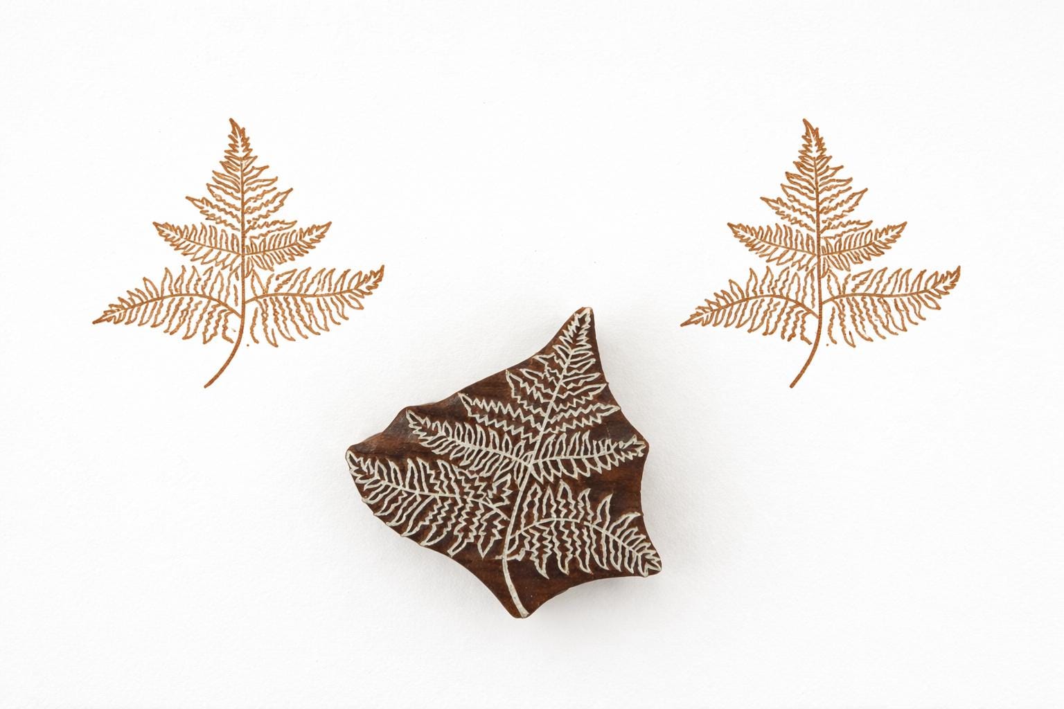 Hand carved fern leaf wood block stamp creating a botanical print on paper or fabric