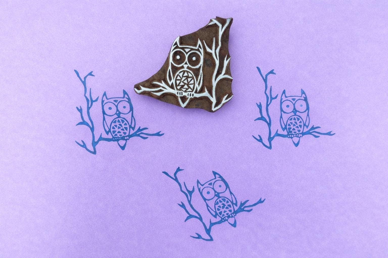 Hand carved owl wood block stamp printing a repeating owl pattern on paper or fabric